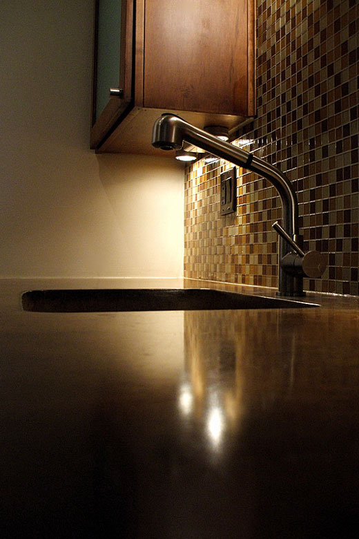 concrete kitchen counter top with undermount sink and faucet